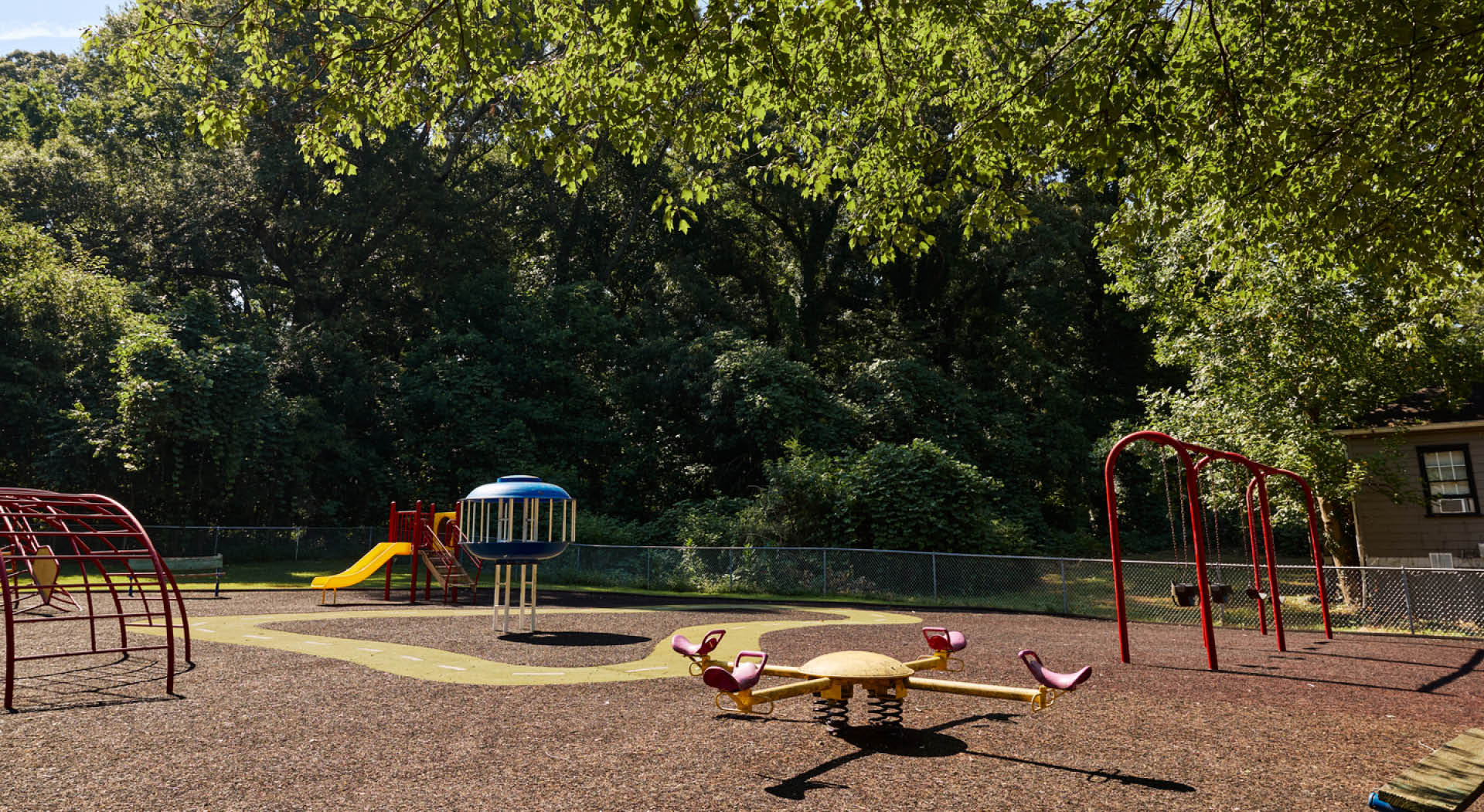 The playground with seesaws, swings, and climbing equipment at Enota Place Playlot. (Photo Credit: Erin Sintos)