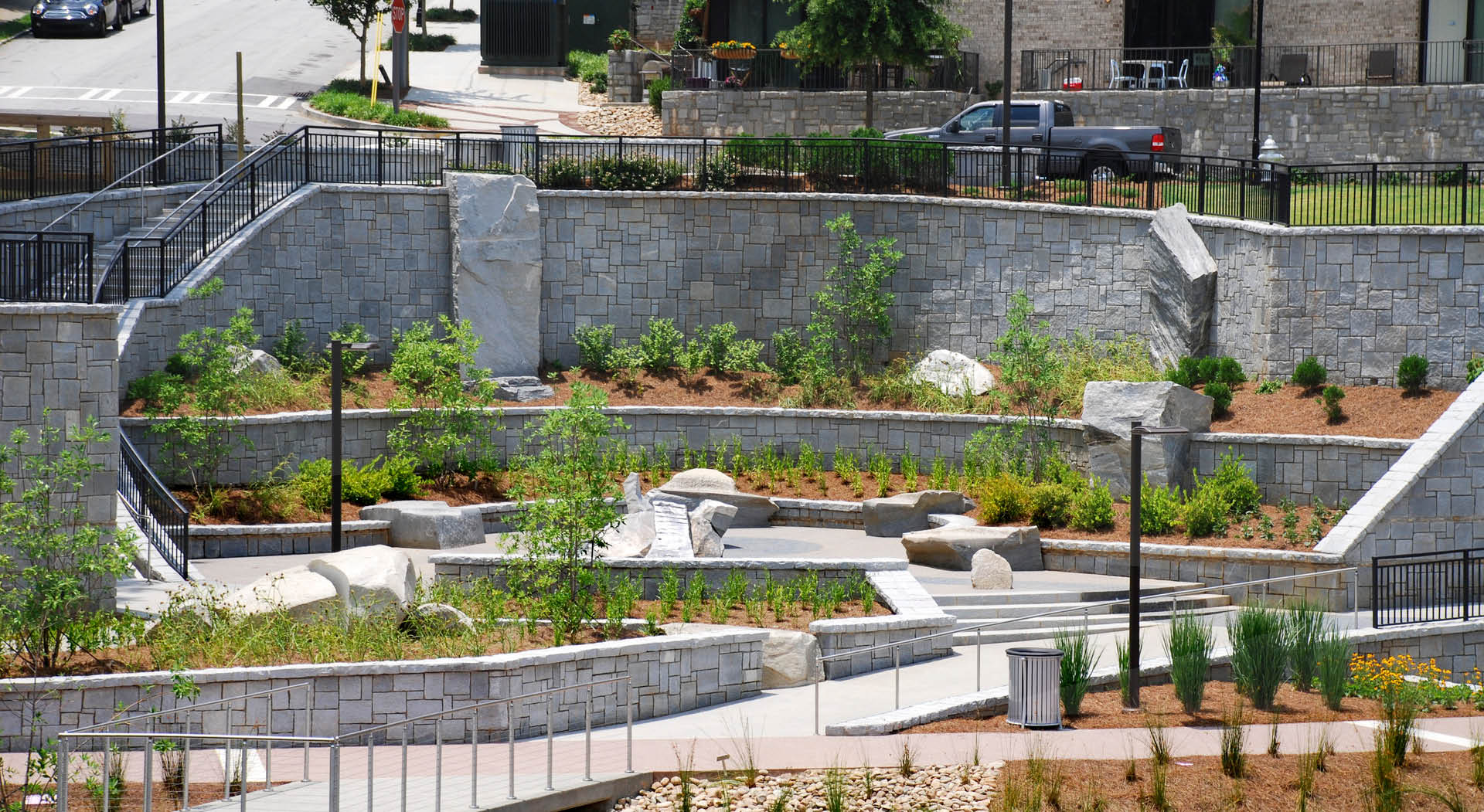 A plaza with granite sculptures made for seating by Maria Artemis.