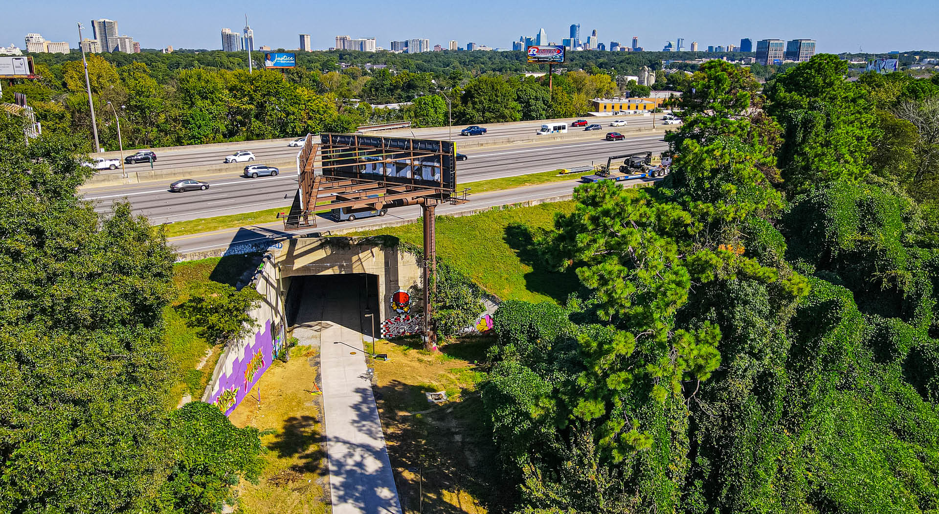 A bird's eye view of the Northeast Trail as it passes under I-85 with the Atlanta skyline in the distance. (Photo Credit: Erin Sintos)