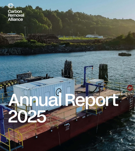 A barge with equipment on a river, surrounded by forested hills, with "Annual Report 2025" text overlay.