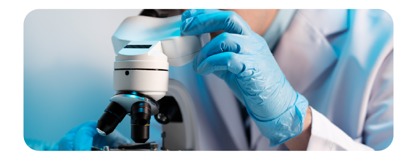 medical laboratory tech using a microscope