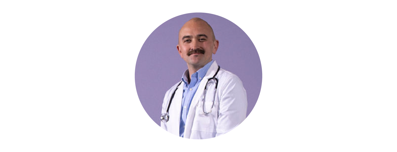 male internal medicine physician wearing a white coat and a stethoscope