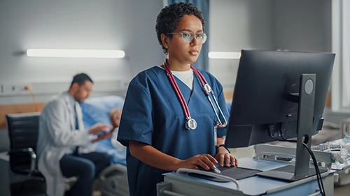 physician on computer in hospital
