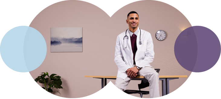 picture of a smiling telehealth doctor leaning on a table