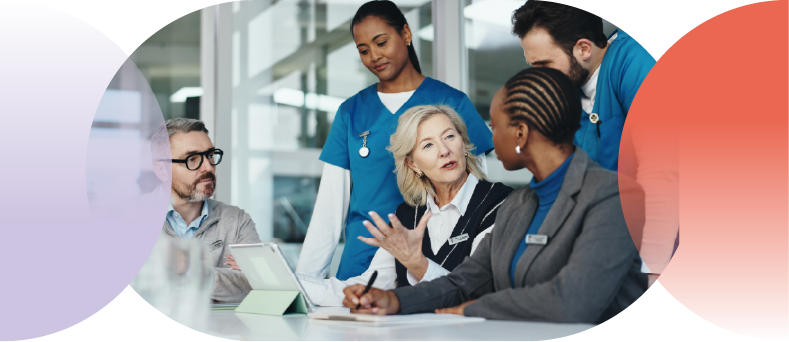 Boardroom with healthcare management leaders speaking with two providers