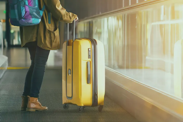 travelling light with a suitcase at a station