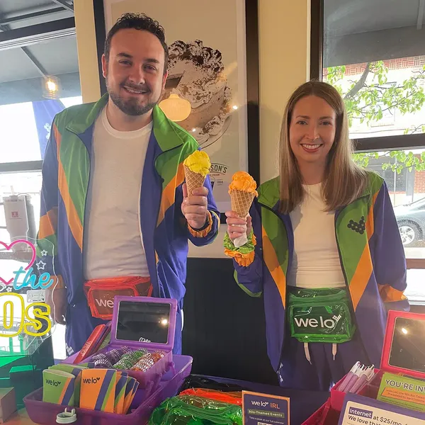 An image of two welo squad members in 90s-style windbreakers holding vibrantly-colored ice cream cones at Johnson’s Ice Cream.