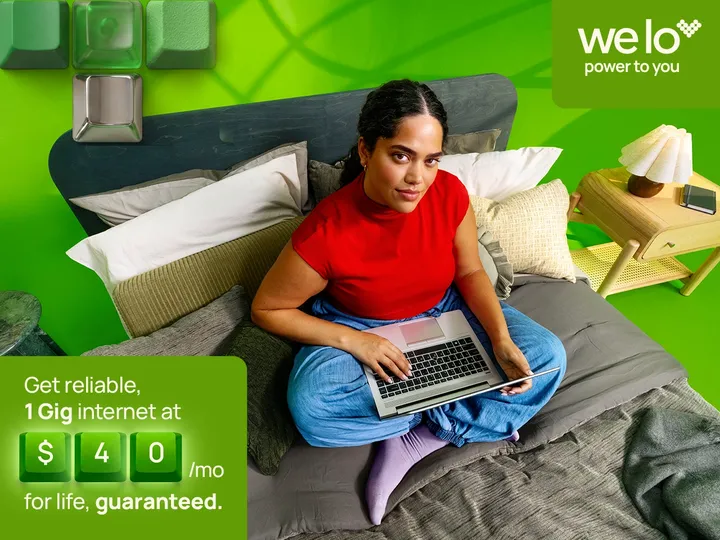 Welo: Reliable 1 Gig internet, $40/mo for life, guaranteed. Man using tablet by food, bright red wall, large computer keys.