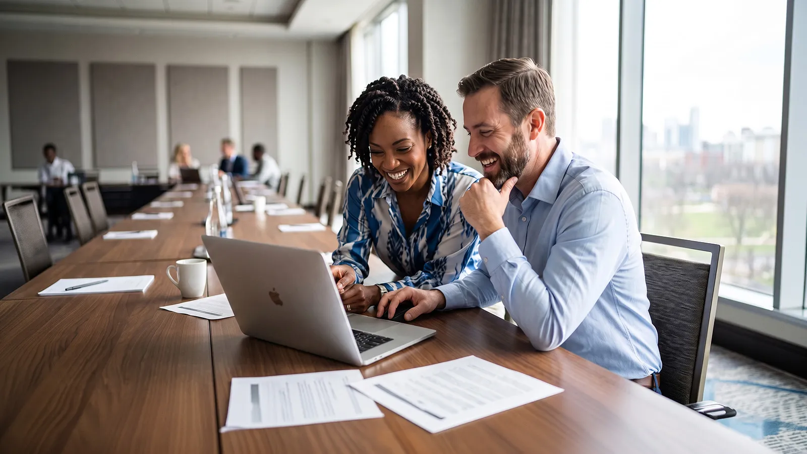 Two leaders learning together using a shared laptop