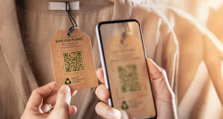 A tag on a shirt that has a QR code detailing sustainability details.