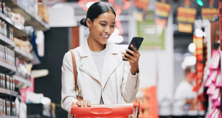 Woman shopping while using her phone.