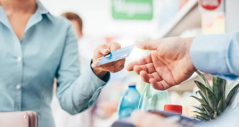 Woman paying at store.