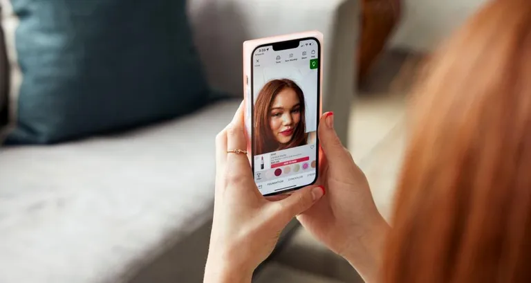 Woman looking at Ulta on her phone.