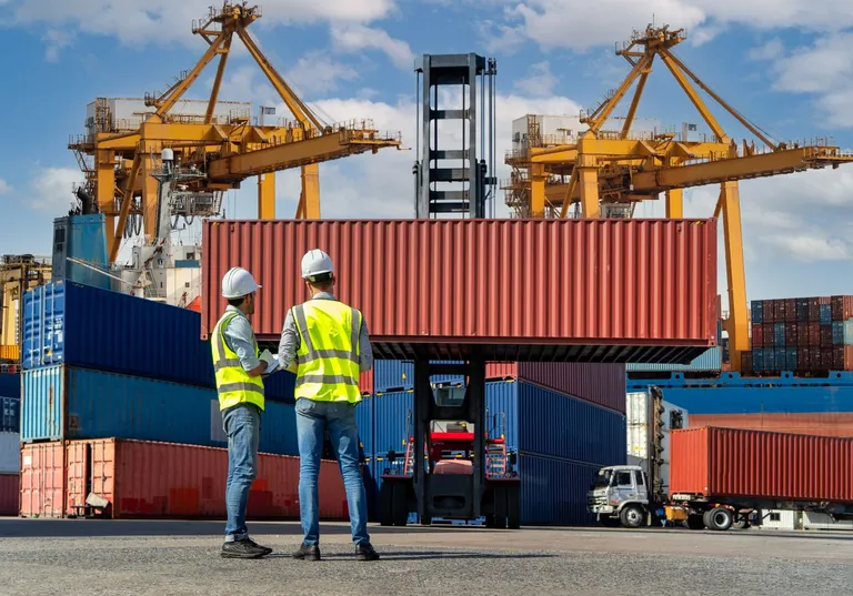 Containers being lifted at a port.
