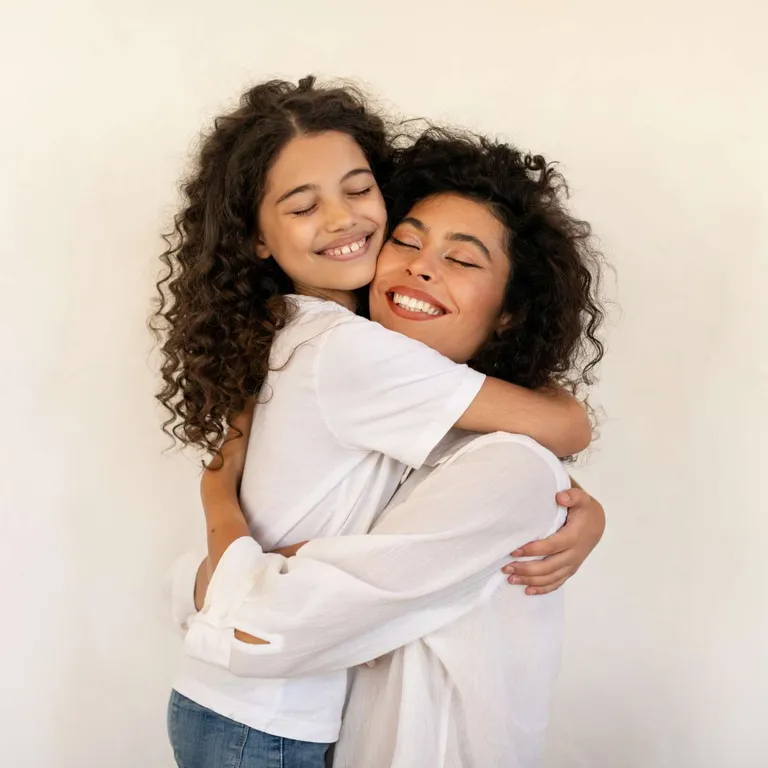 Mom and daughter hugging.