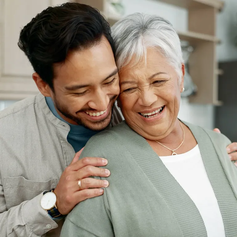 A son and mother hugging.
