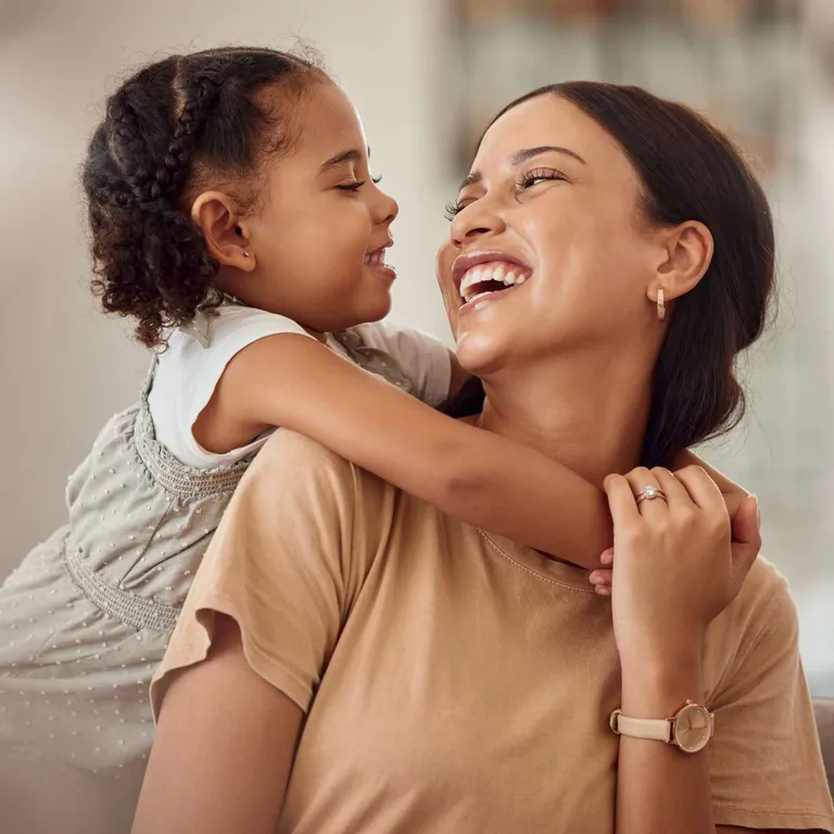 A mother and daughter hugging.