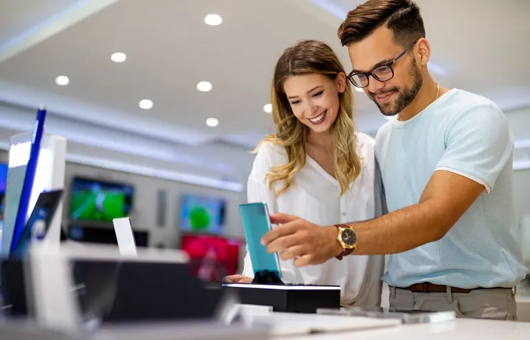 A couple shopping for a phone.