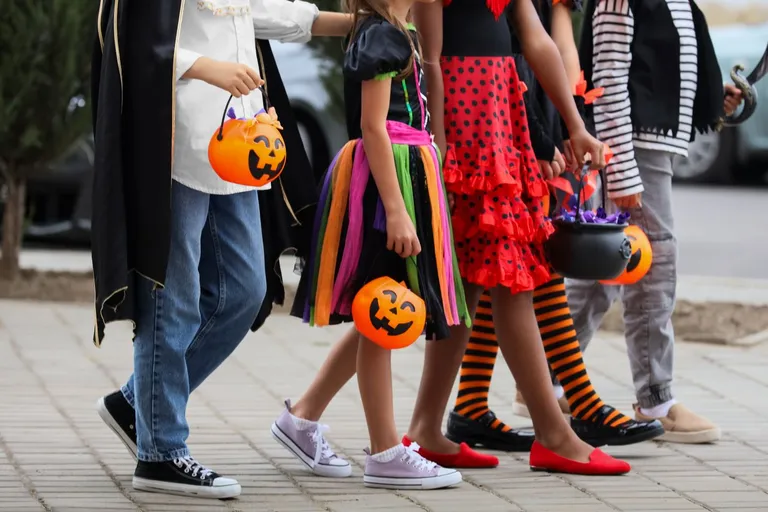 Kids walking in Halloween costumes.