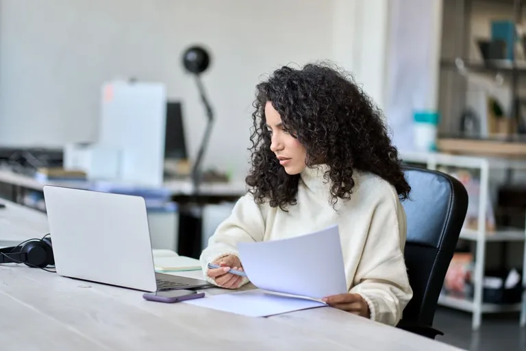 A woman working on her computer.