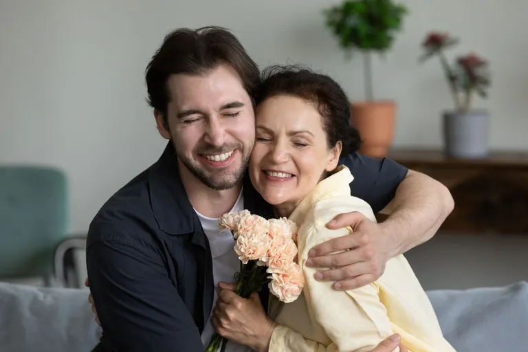A mother and son hugging.