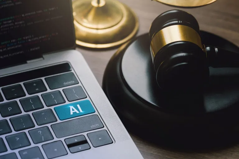 AI on a computer keyboard next to a gavel.