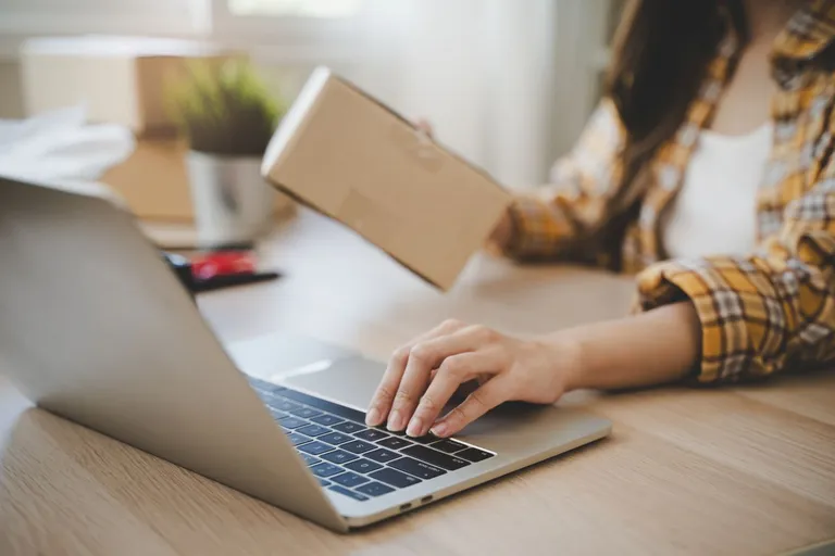 Individual working on laptop.