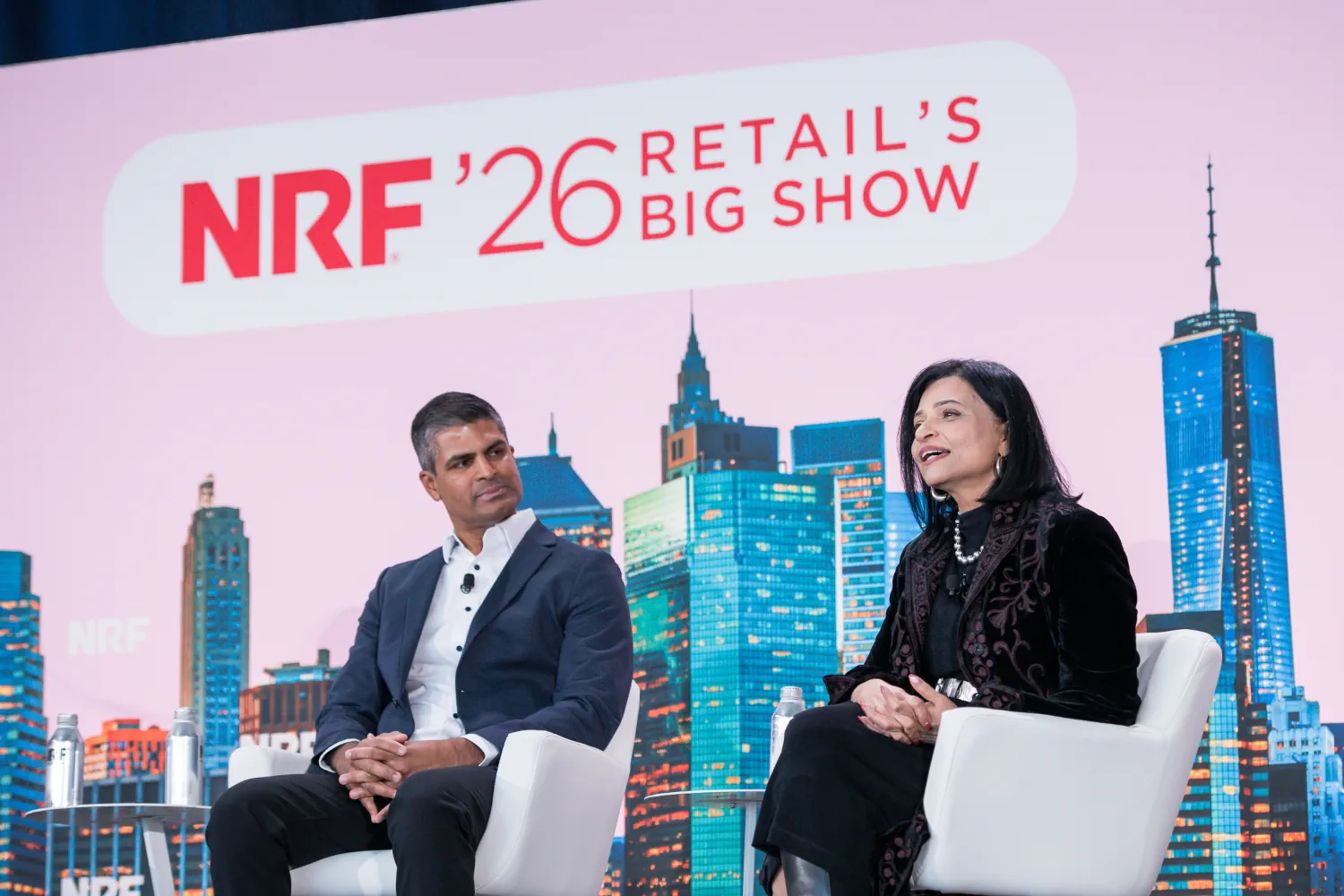 Samir Desai listens to Neelima Sharma's comments from the NRF'26 stage.