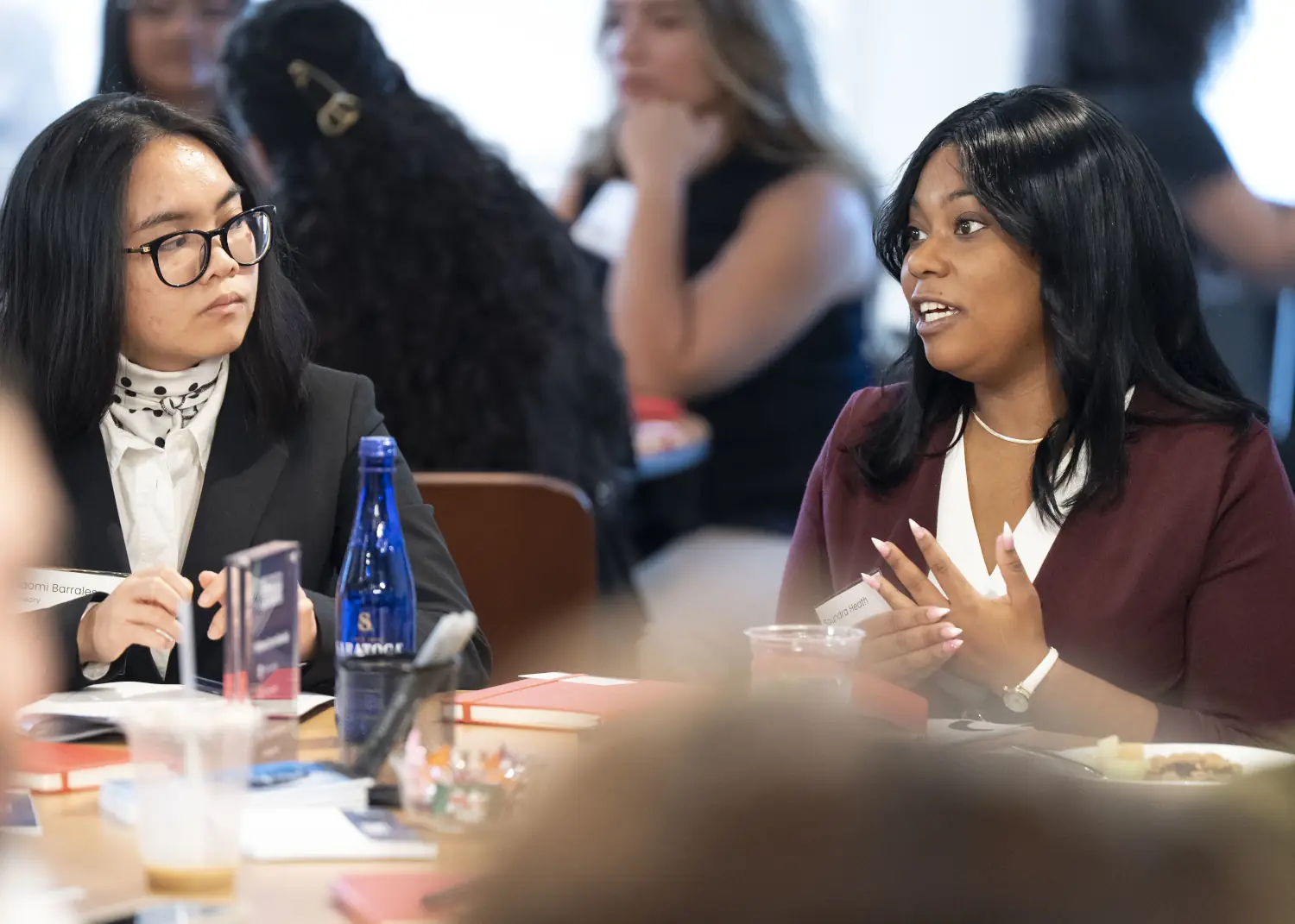 Two NRF Foundation Emerging Leaders 2026 Summit attendees discuss the topic at hand at their roundtable.
