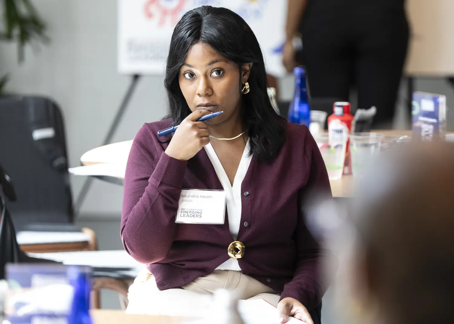 A NRF Foundation Emerging Leaders 2026 Summit attendee ponders the words of an another attendee.