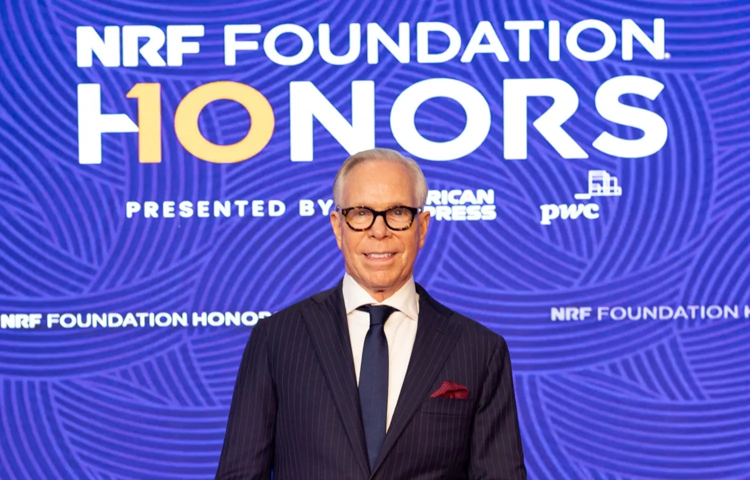 Tommy Hilfiger poses in front of the NRF Foundation Honors backdrop at the 2025 gala. He is the recipient of the The Visionary recognition at the 2025 NRF Foundation Honors.