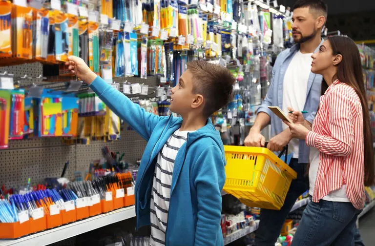Young boy and his family go school supplies shopping