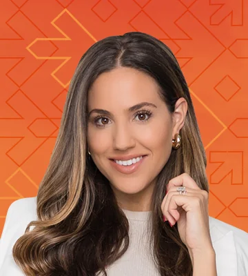 Professional portrait of Julia Furnari. The photo's background has a gradient of orange and red colors along with arrows pointing right, consistent with the NRF Foundation Student Program branding.