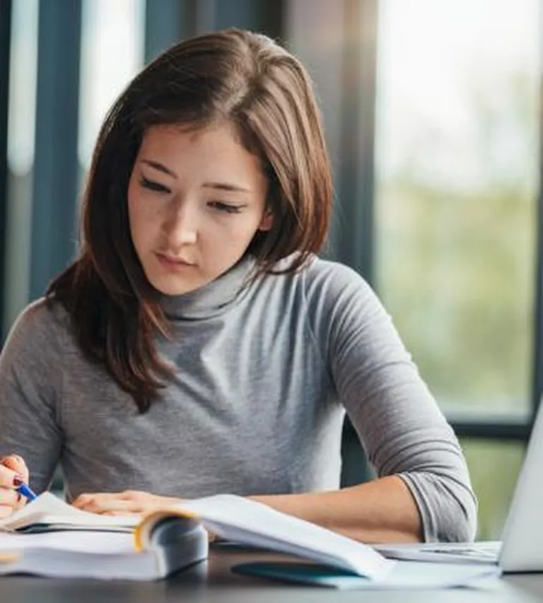 Woman working at a desk.