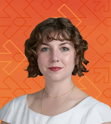 Professional portrait of Kelsey Chrysostomou. The photo's background has a gradient of orange and red colors along with arrows pointing right, consistent with the NRF Foundation Student Program branding.