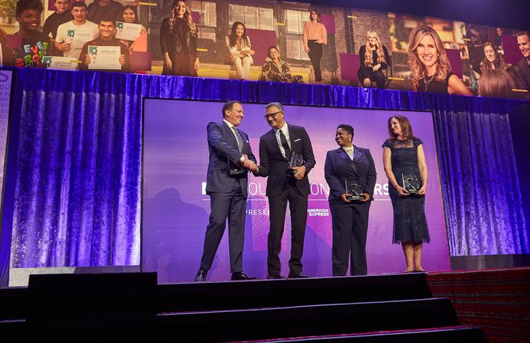 Four NRF Foundation Honors honorees stand on stage, smiling and holding their awards.