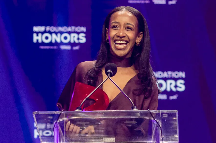 Sarah Starko happily accepts the NRF Foundation Next Generation Scholarship, giving a short acceptance speech on stage at Honors '26.