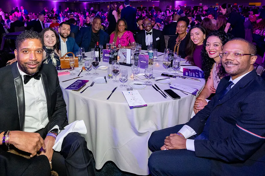 Tonya Hallett's table of colleagues and guests pose for the camera at the Honors '26 dinner.
