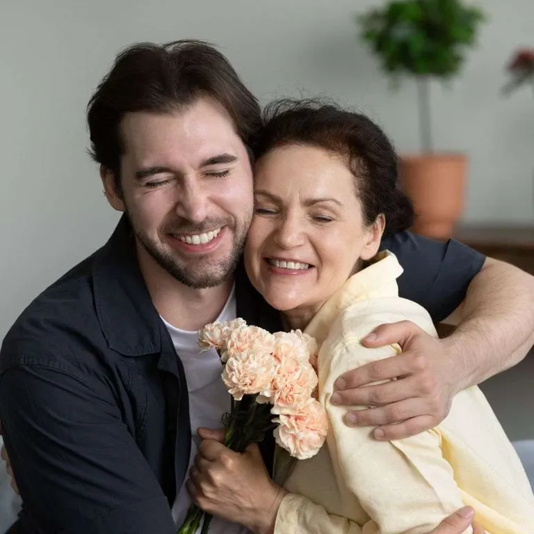 A mother and son hugging.