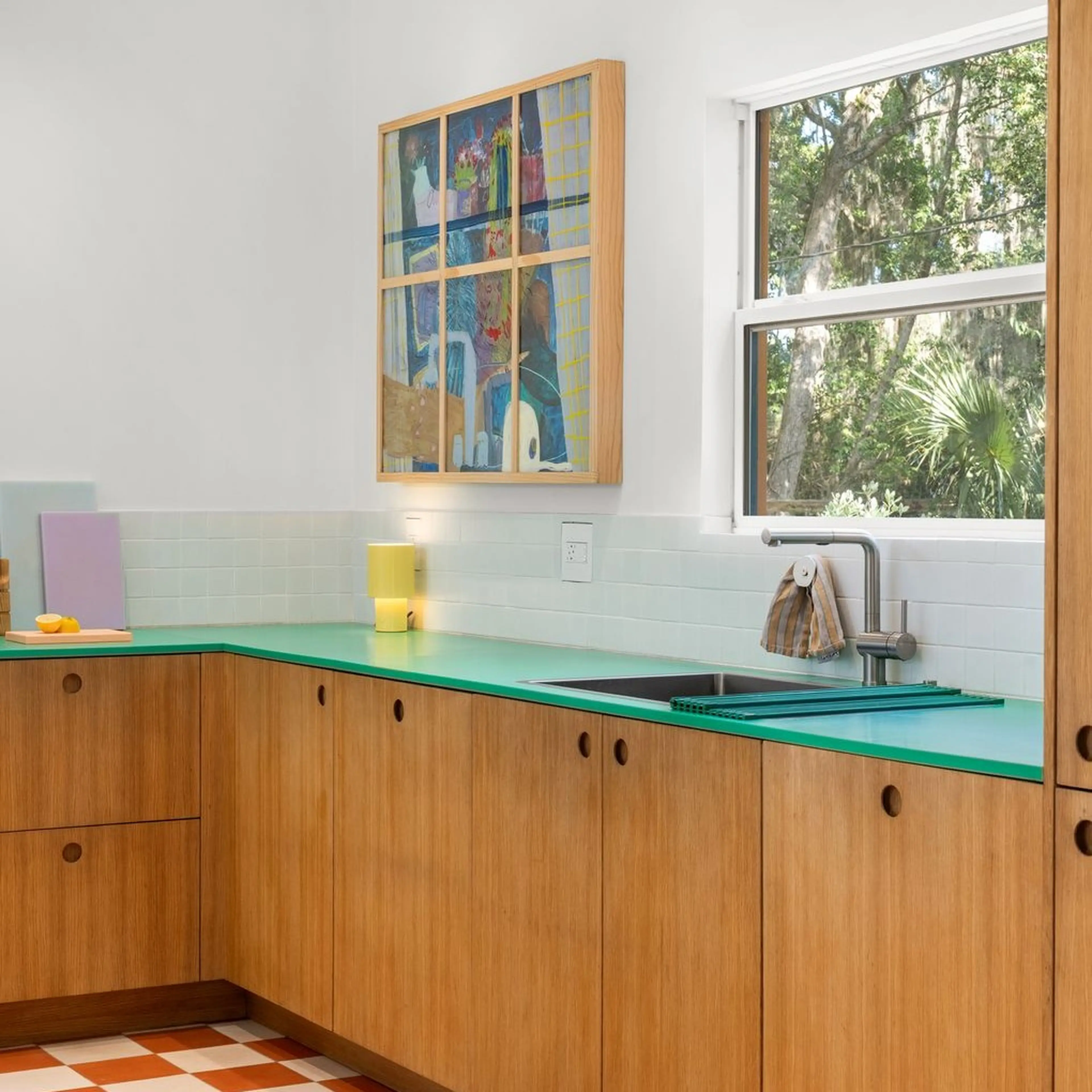 Midcentury sink with green counter tops and wooden cabinets
