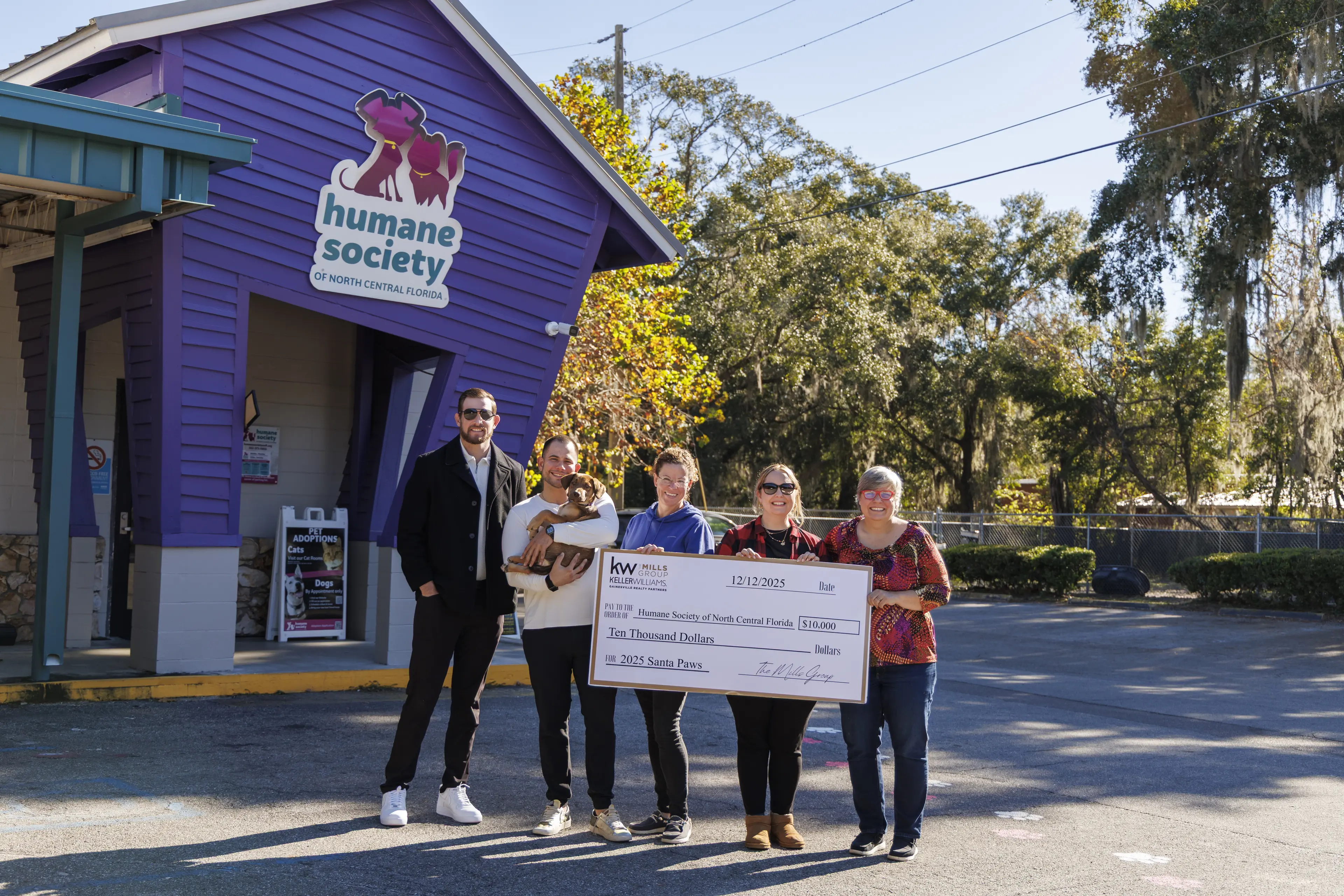 The Mills Group presenting a $10,000 check to the Humane Society of North Central Florida after the 4th Annual Santa Paws 5K-9 fundraiser.