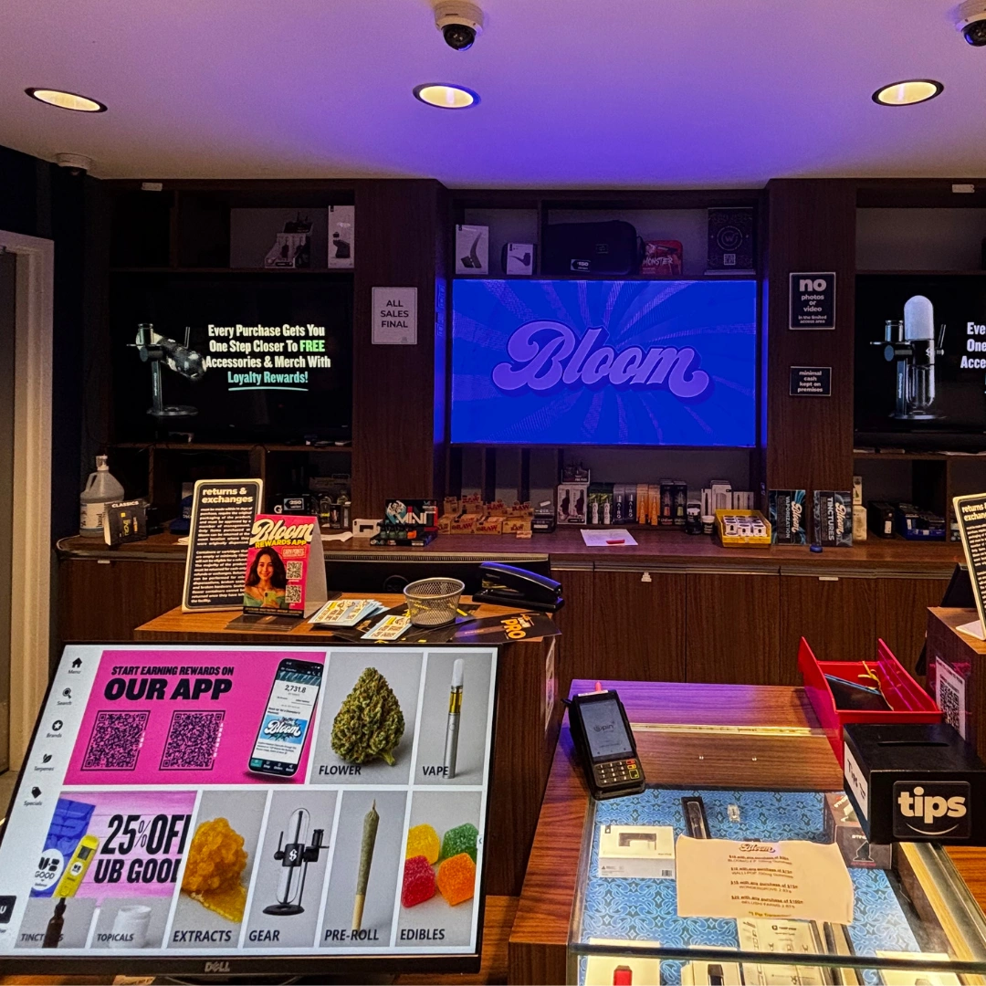 Bloom Painesville dispensary product menu screen displaying the differerent kinds of products you can purchase and accessory wall behind the counter