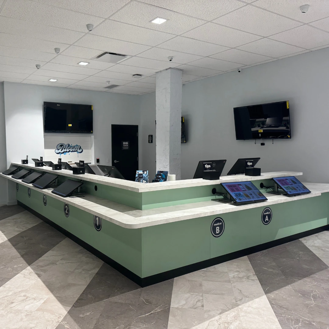 Bloom Athens marijuana dispensary checkout counter with menu screens for medical and recreational product selection
