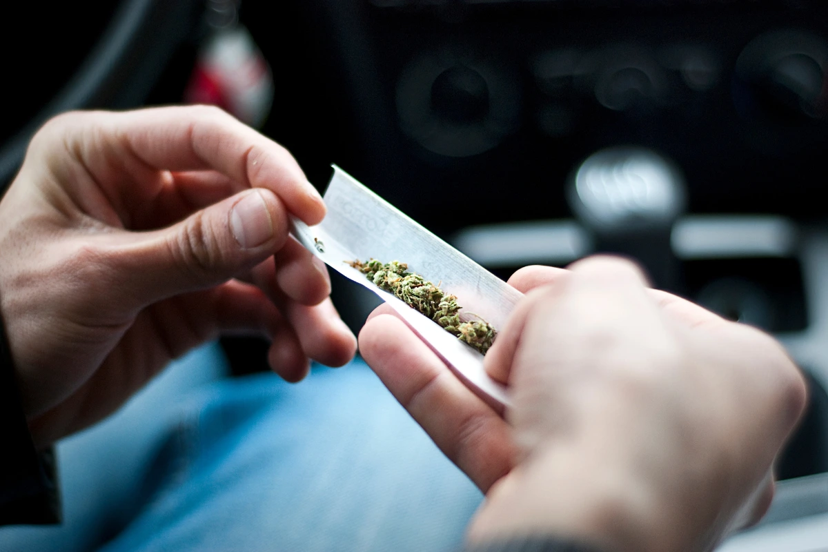Cannabis being prepared inside a vehicle illustrating Ohio cannabis DUI and vehicle possession laws