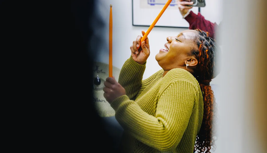A woman having fun while air drumming