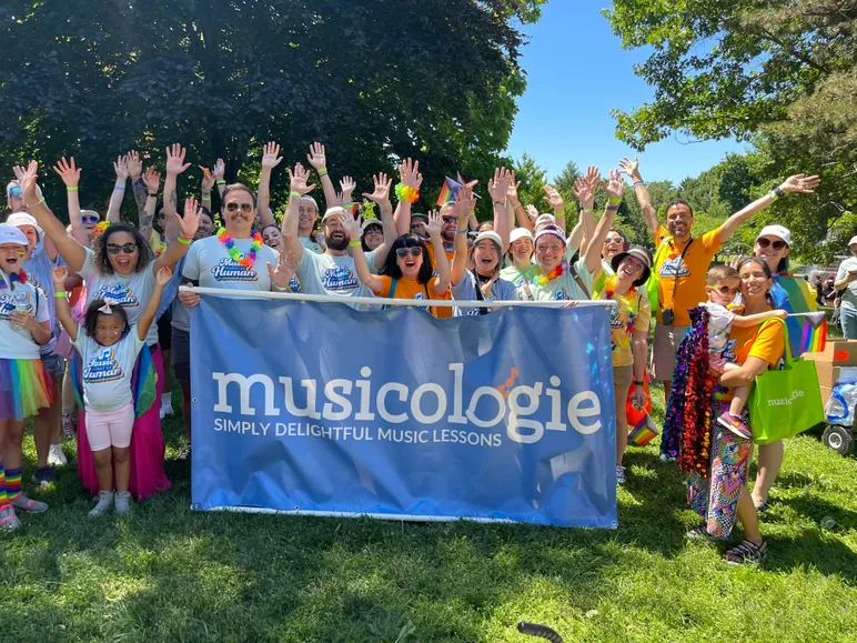 Musicologie Group with Hands in the air with Banner
