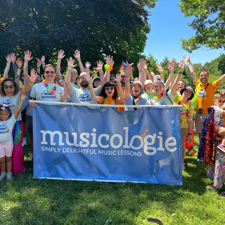 Musicologie Group with Hands in the air with Banner