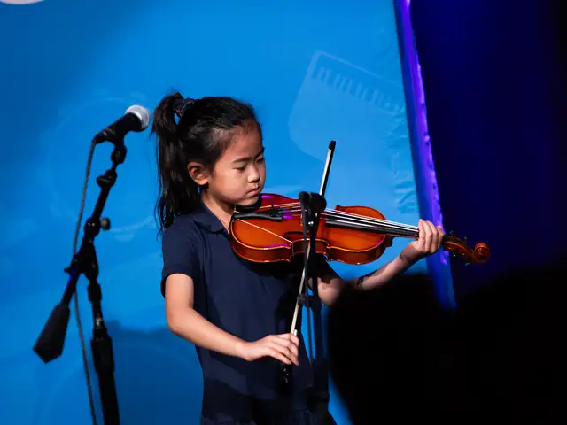 Girl Playing the Violin on Stage