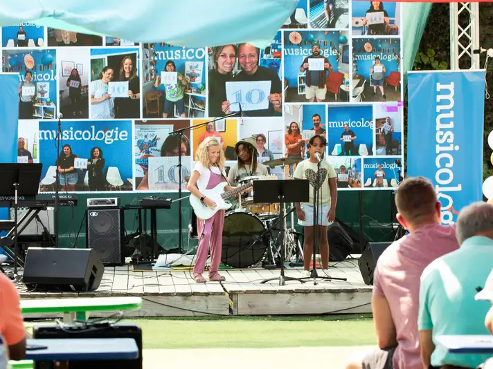 Musicologie rock band performing on stage