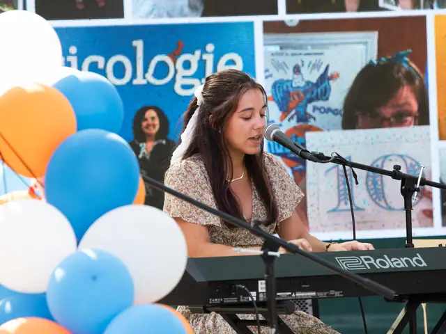 Girl on stage singing and playing the piano